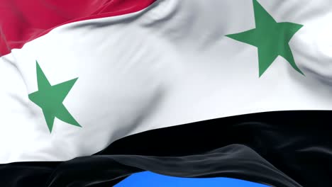 flag of syria waving at wind with blue sky in slow, loop