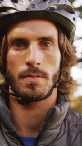 portrait of mountain biker standing with arms crossed