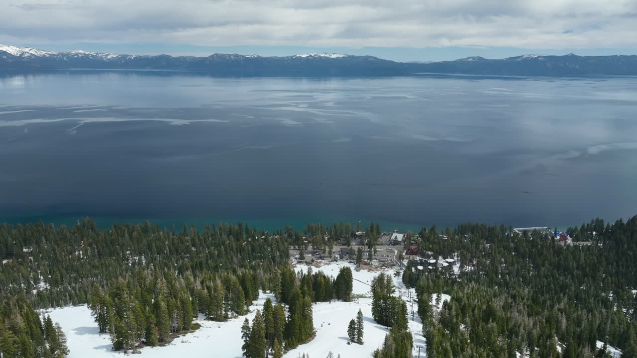 Aerial view backwards over snowy ski slopes at Lake Tahoe, winter in USA