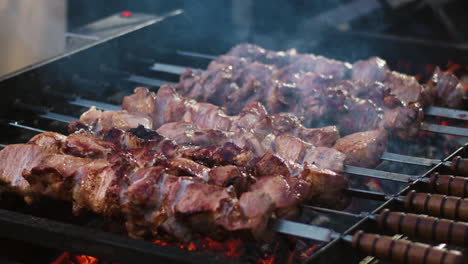 Closeup-pork-kebabs-barbecuing-at-brazier-outdoor.