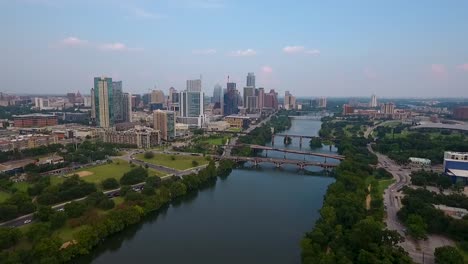 aerial: drone flying towards austin, texas on a beautiful sunny day