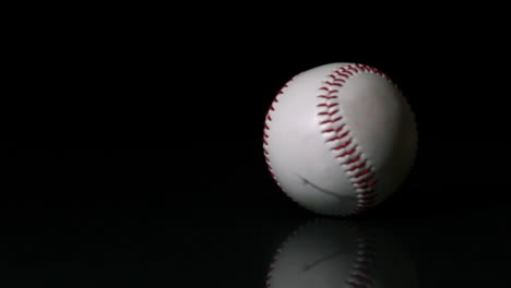 baseball spinning on black surface