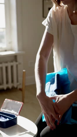 woman applying ice pack to injured arm