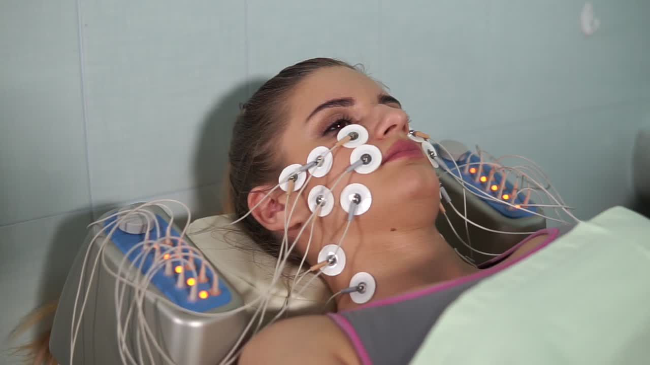 Woman Undergoing Facial Electrotherapy Treatment
