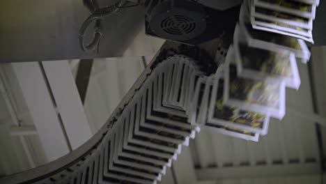 newspapers move along an overhead conveyor belt at a newspaper factory 7