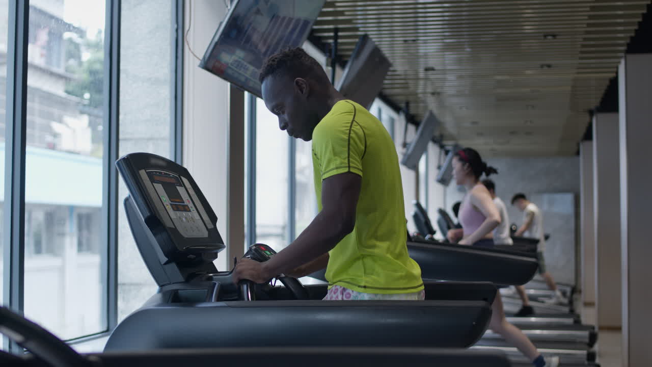 Man working out on a treadmill in a modern gym