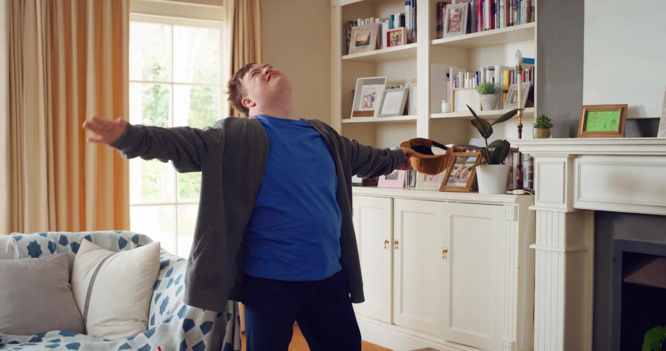 Young Man with Down Syndrome Dancing Happily in Living Room