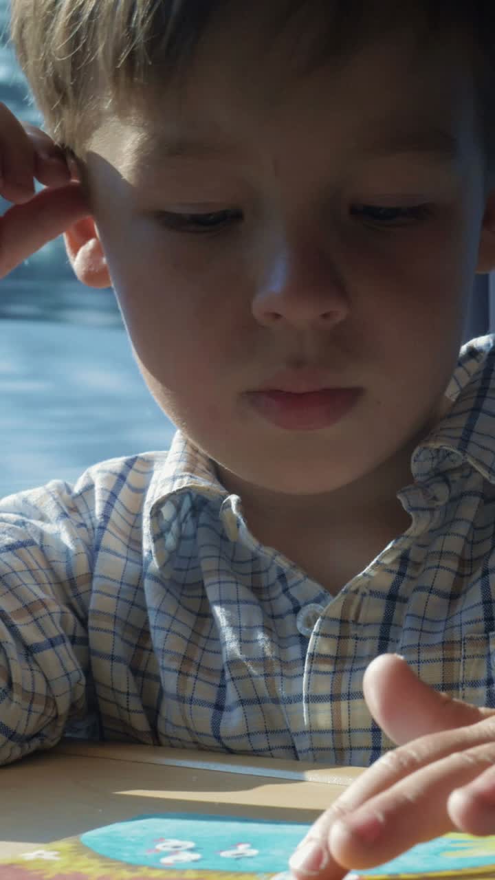 Close-up portrait of a young boy in a plaid shirt