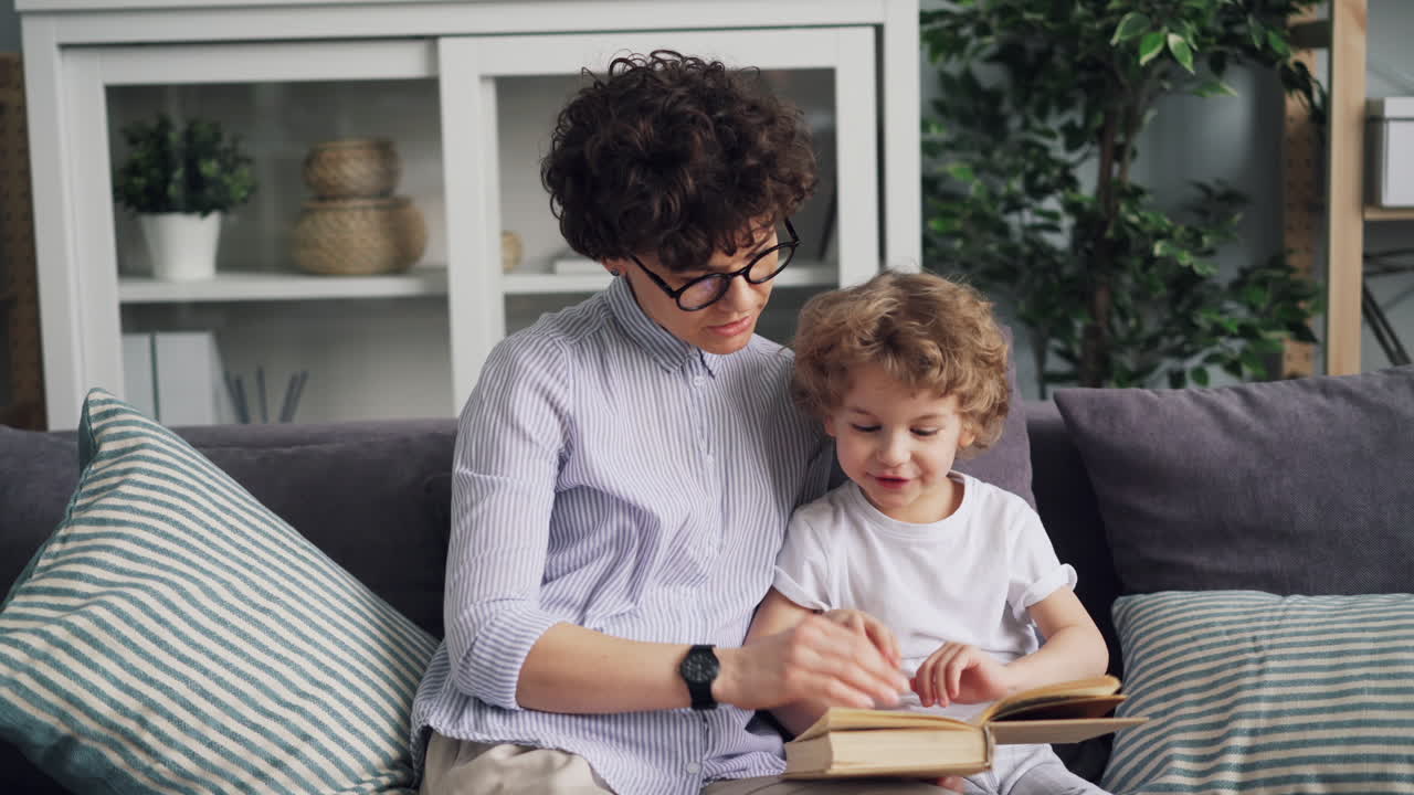 Mother and Son Reading Together on Couch