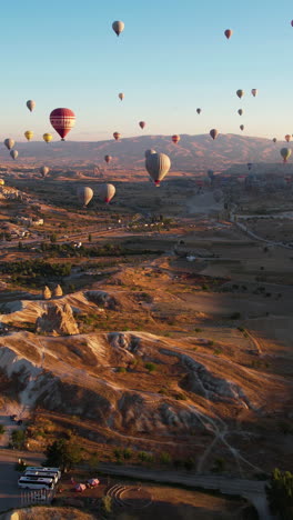 hot air balloons soaring over cappadocia landscape at sunrise