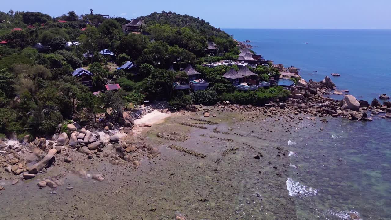 Aerial drone footage of Lamai Beach in Koh Samui, Thailand, featuring turquoise ocean, rocky shoreline, tropical island horizon, and scenic coastal landscape under clear tropical skies