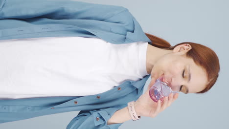 Vertical-video-of-The-sick-woman-drinks-a-lot-of-water.