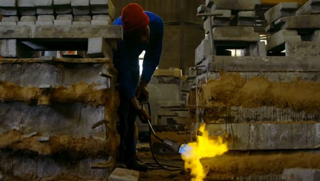 worker heating metal mold with blow torch in foundry workshop 4k