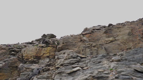 slow motion driving past a rock face