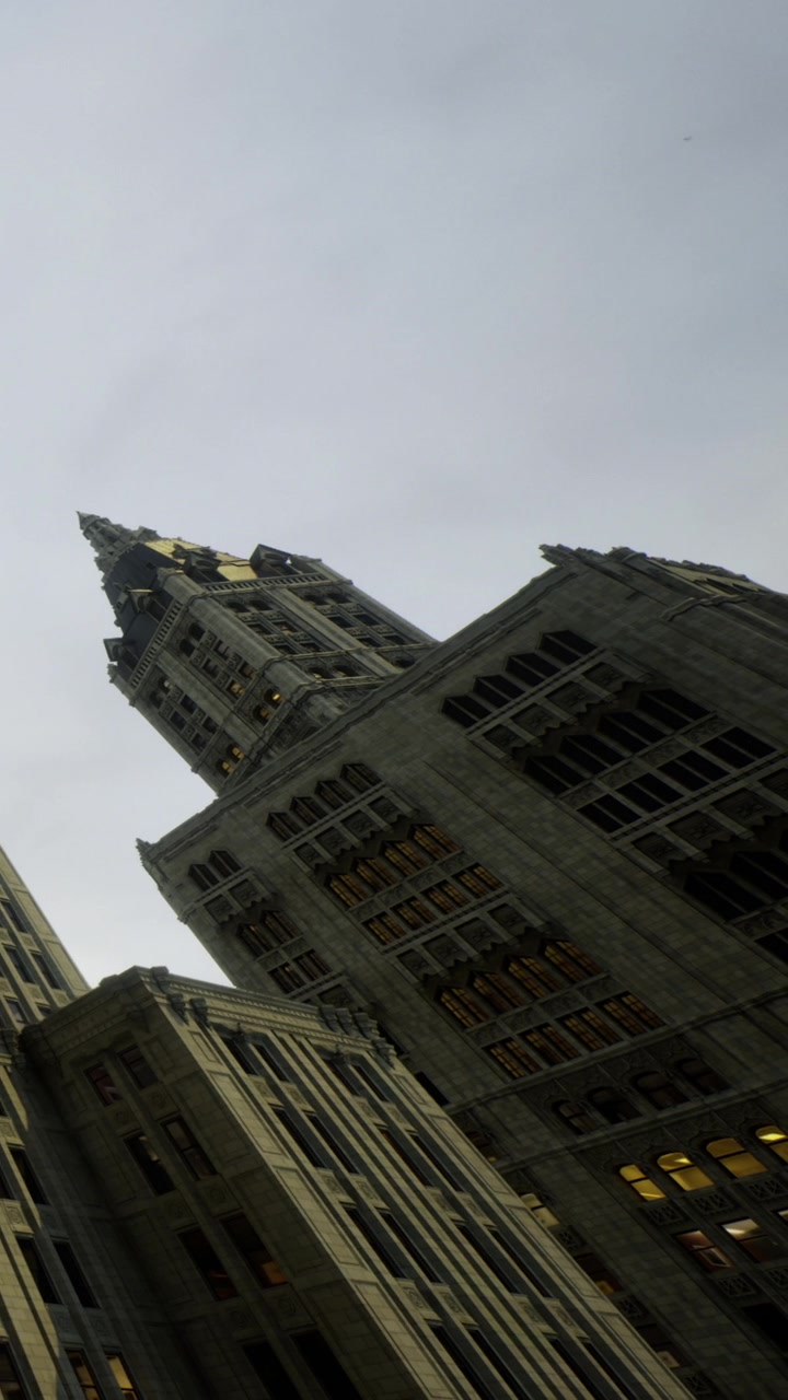 City buildings rise towards the cloudy sky during the early evening hours