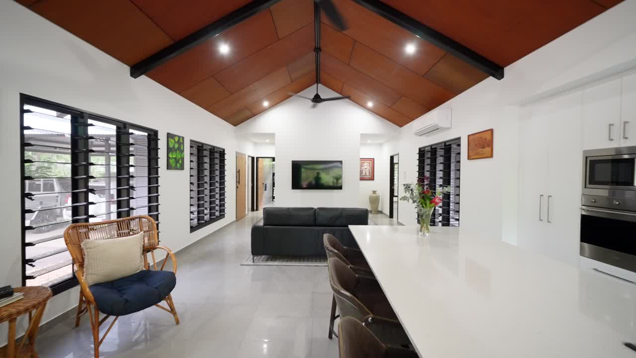 Spacious open-plan tropical villa interior with high ceilings, natural light, and luxury finishes, ideal for modern living