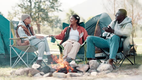 friends camping around a campfire
