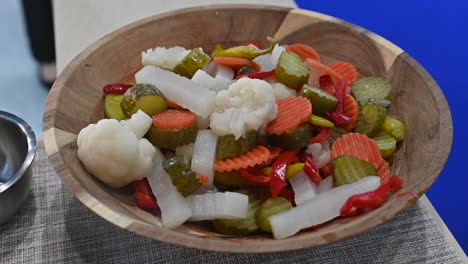 mixed vegetable pickles are displayed during the gulf food exhibition, united arab emirates