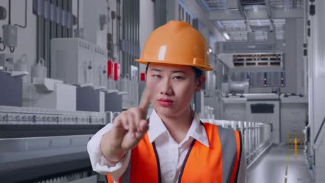 close up of asian female engineer with safety helmet disapproving with no index finger sign at pharmaceutical factory, vaccine production facility