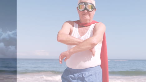 animación de nubes sobre un hombre caucásico mayor vestido con disfraz de superhéroe en la playa