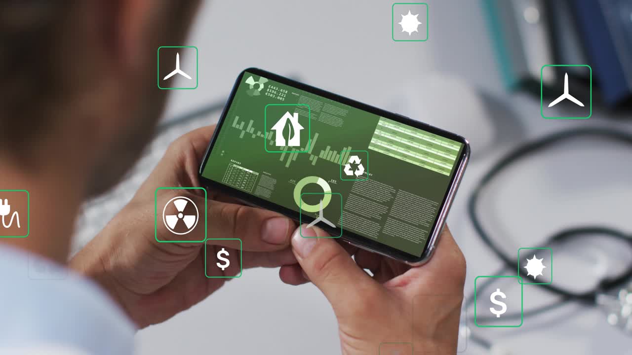 Man raising smartphone at desk while monitoring green energy data and showing floating energy icons