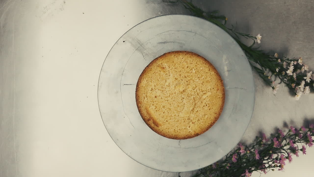 Placing a cake on a plate closeup