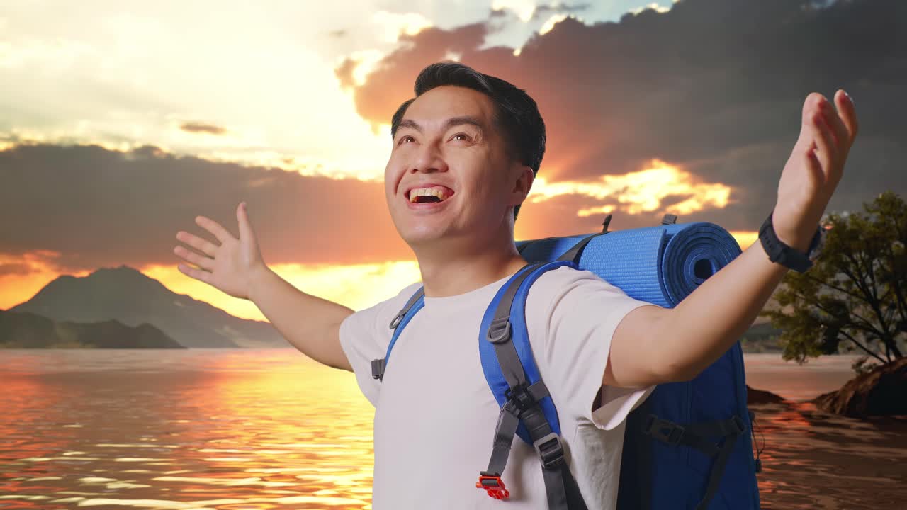 Close Up Side View Of Asian Male Hiker With Mountaineering Backpack Spreading Arms Enjoy Looking The View Around At A Lake