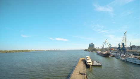 panorama of the river port with many loading cranes. water area on a sunny day.