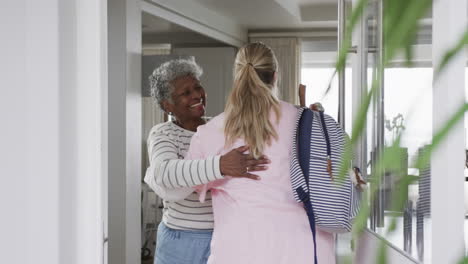 Smiling-caucasian-nurse-hugging-with-senior-african-american-woman-patient,-slow-motion