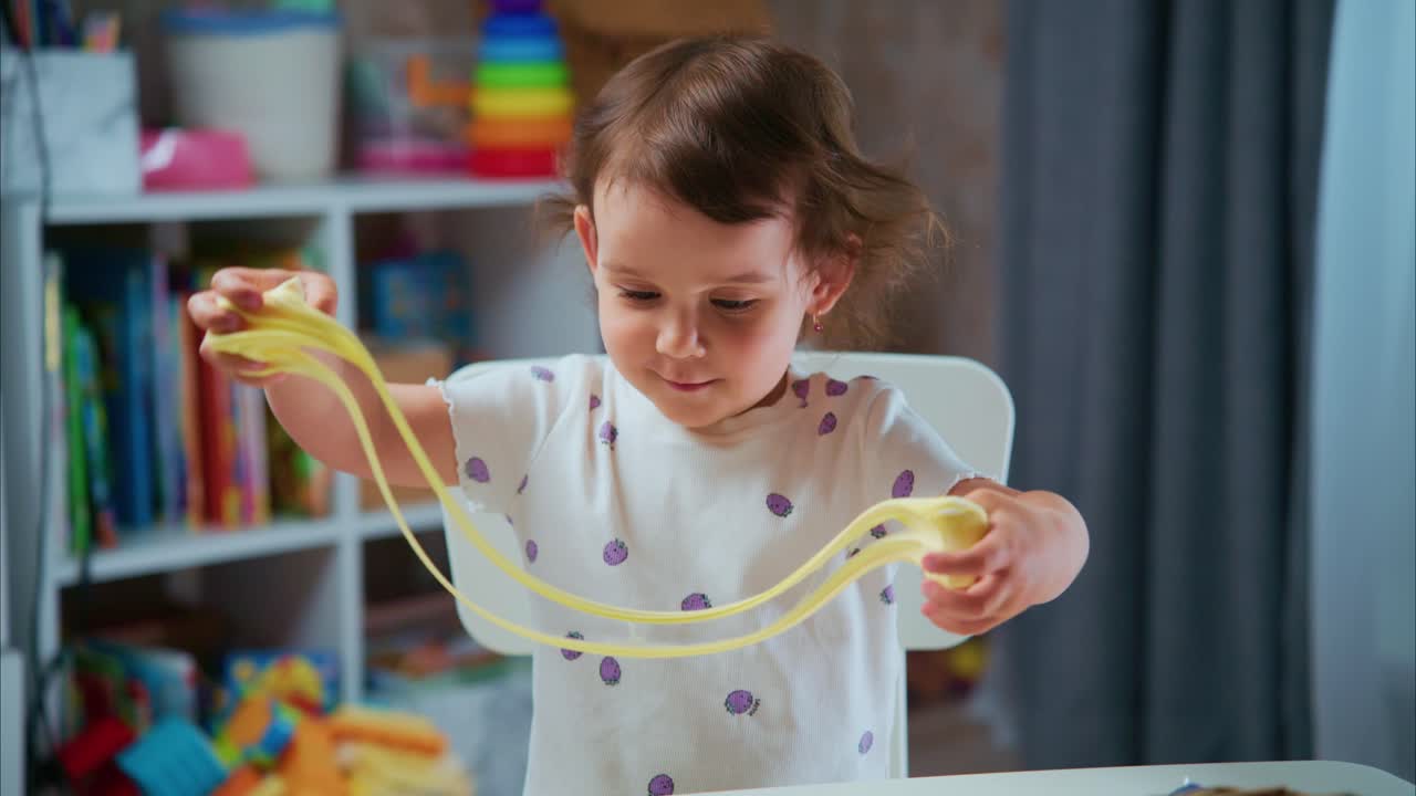 A Delightful Moment of Play: A Young Child Engaged in Creative Fun with Play-Dough at Home, Showcasing Joy and Imagination in a Colorful Environment