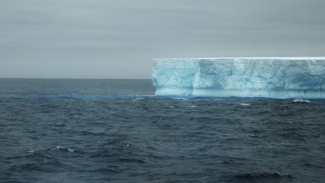 close up of a tabular iceberg on a cloudy day