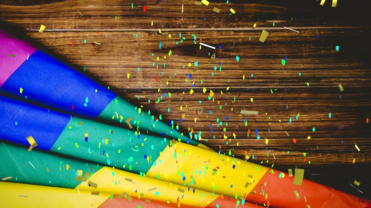 animación de confeti y bandera del arco iris sobre un fondo de madera