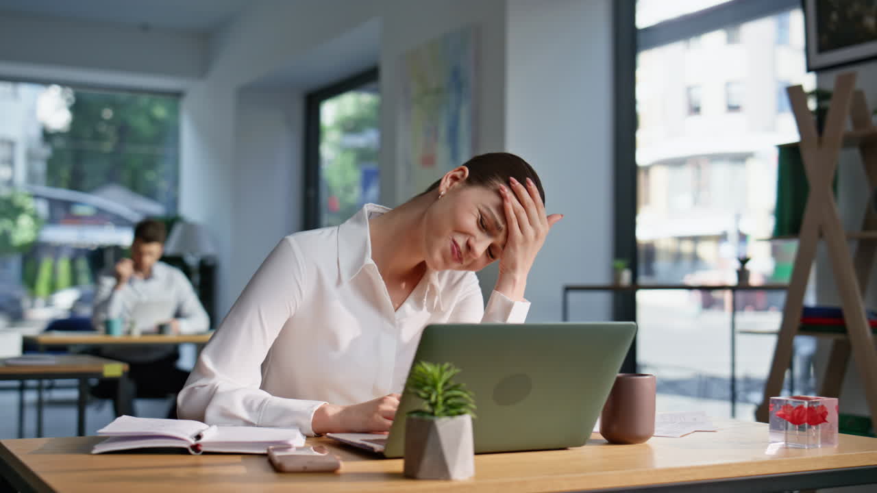 Shocked woman looking laptop worried bad news sitting coworking space closeup