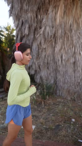 woman jogging outdoors with headphones