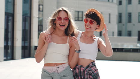 two women friends laughing outdoors