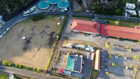 Town-on-a-tropical-island,-Grenada-aerial-reveal