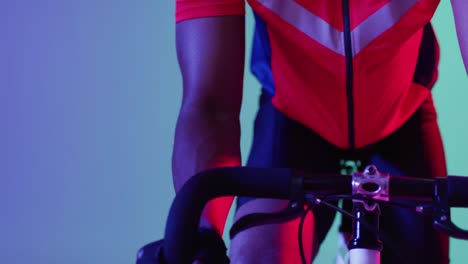 african american male cyclist with bicycle over neon blue lighting