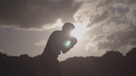 Man-Boxing-In-The-Park-With-The-Sun-Behind-Him-In-Slow-Motion---Ungraded