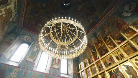 a wonderful bright large chandelier under the dome of an orthodox christian church. very beautiful object