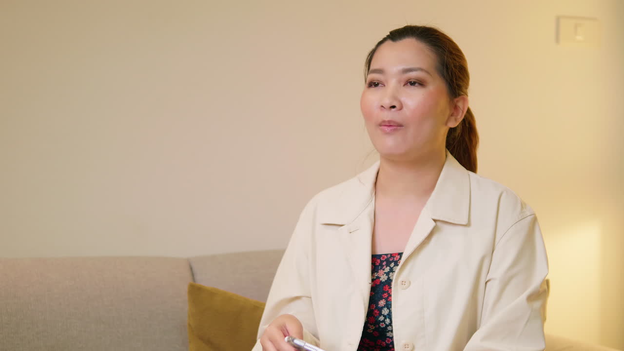 Young adult woman explaining and interview video online communication with casual clothing and speaking in room