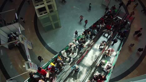 crowded escalator in a modern shopping mall