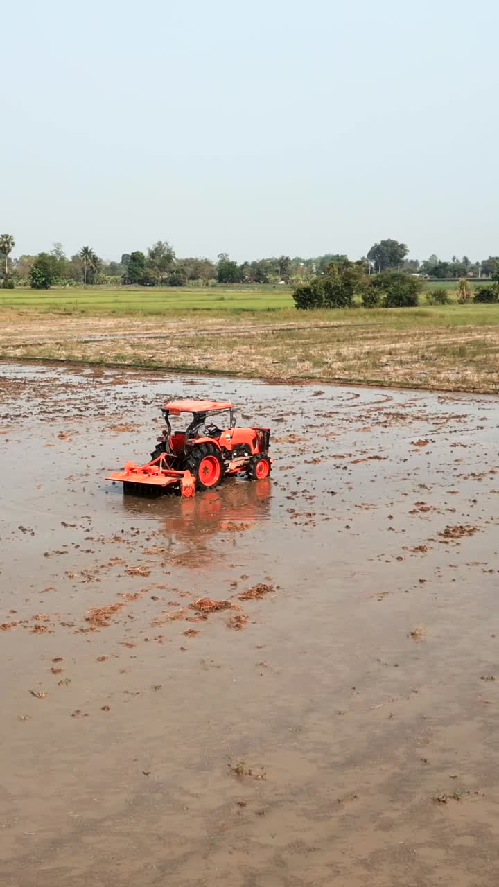 Tractor working in a paddy field