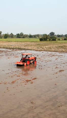 tractor working in a paddy field