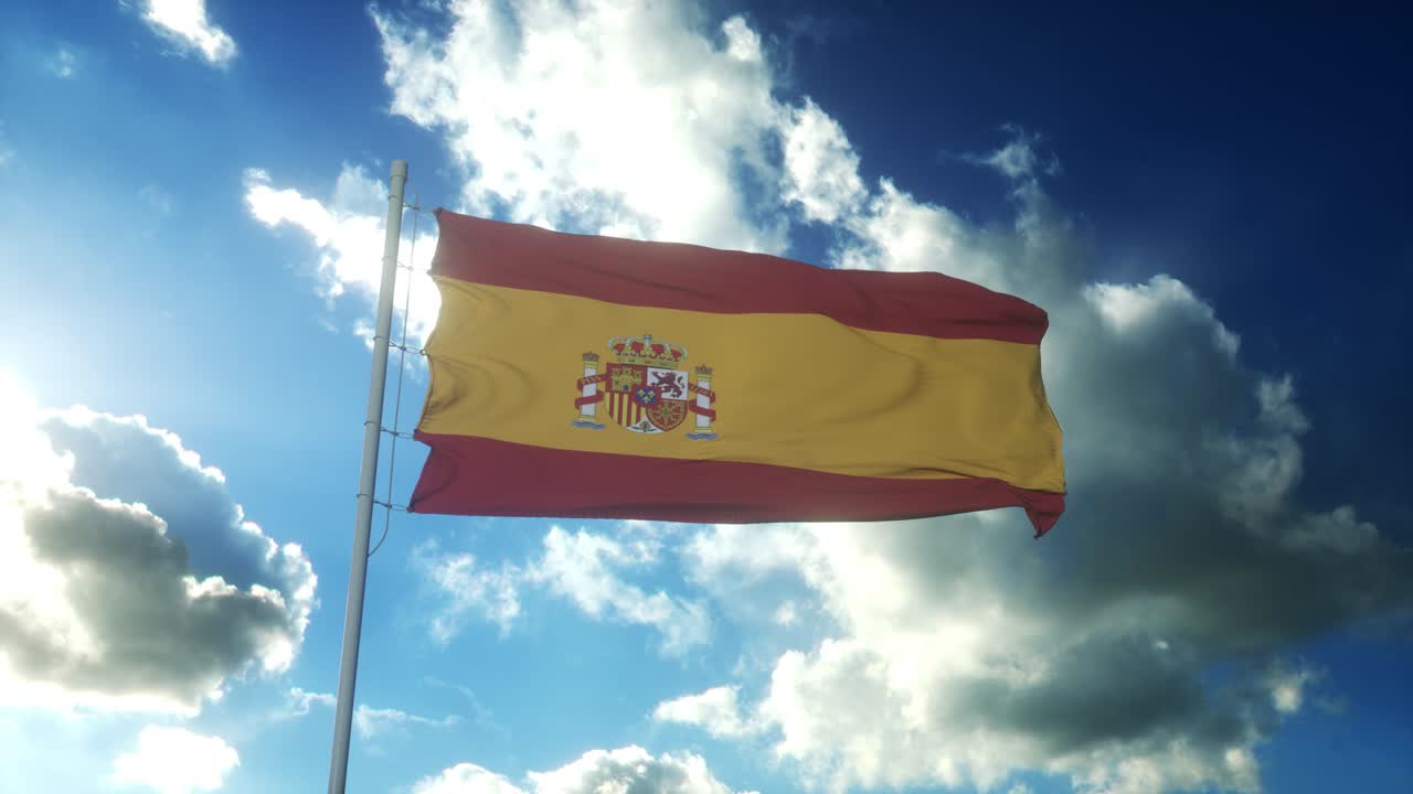 Flag of Spain waving at wind against beautiful blue sky