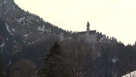 Neuschwanstein-castle-in-the-distance-view-from-a-street-of-Schwangau-4k-footage