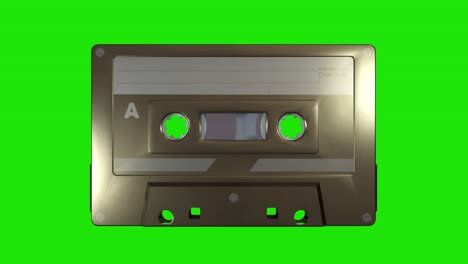 un cassette de música dorado en un fondo de pantalla verde