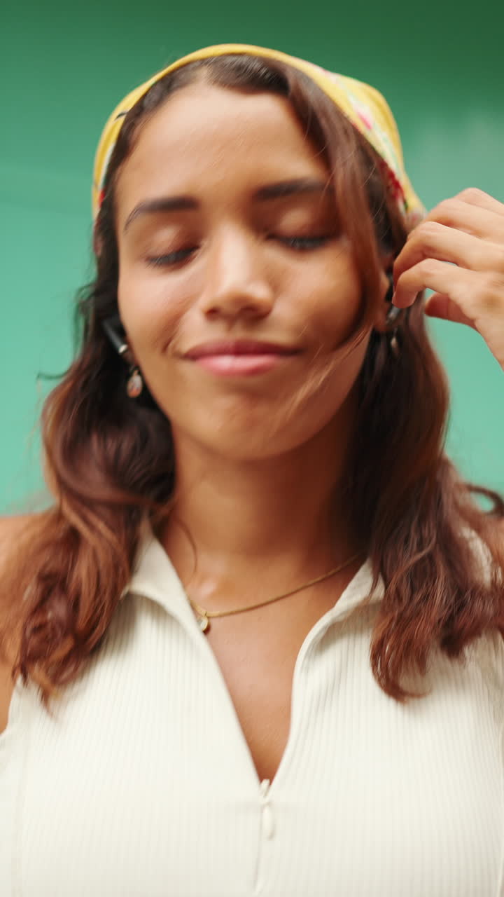 Woman wearing headscarf, jewelry, and casual wear
