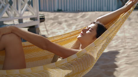 happy girl lying hammock closeup. attractive smiling woman enjoying sunlight