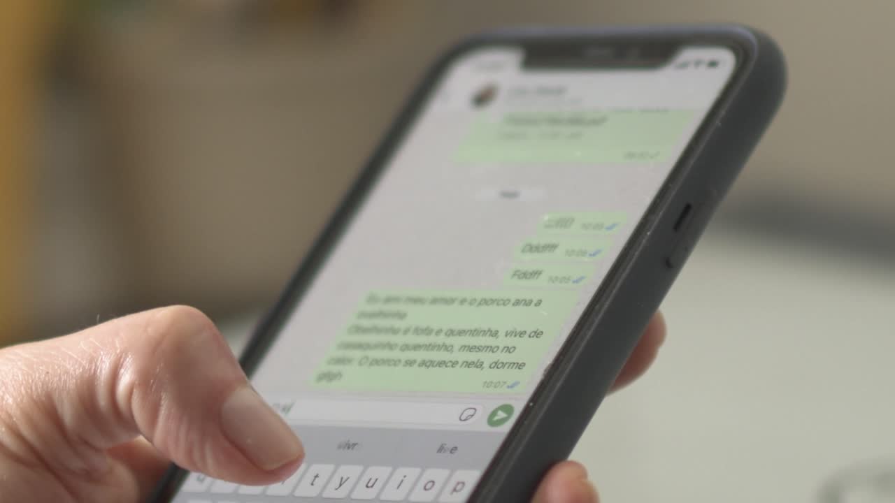 Closeup, female respoding to text message on cell phone using thumb