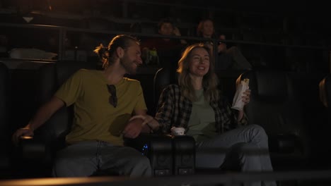 boyfriend and girlfriend have date at cinema. love couple watch comedy film